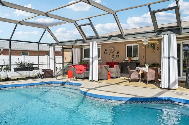 view of pool featuring outdoor lounge area, a lanai, ceiling fan, and a patio area