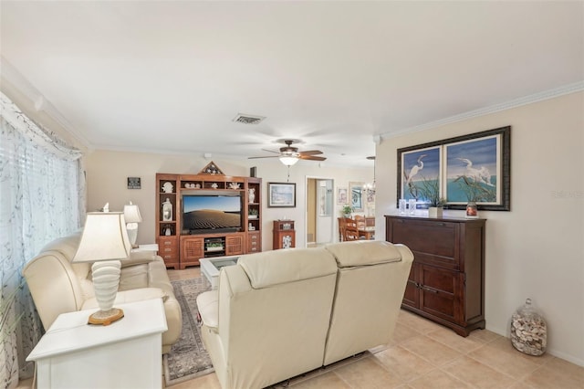 tiled living room with ceiling fan and crown molding