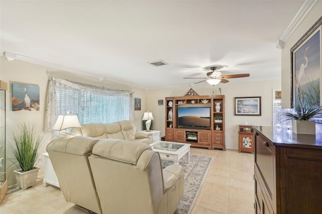 tiled living room with ceiling fan and crown molding