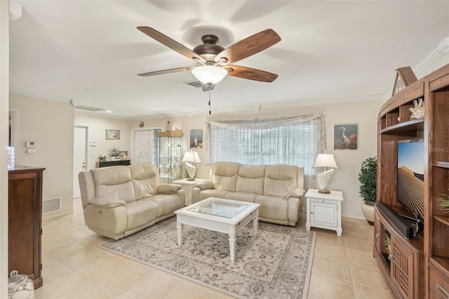 living room with ceiling fan, light tile patterned floors, and ornamental molding