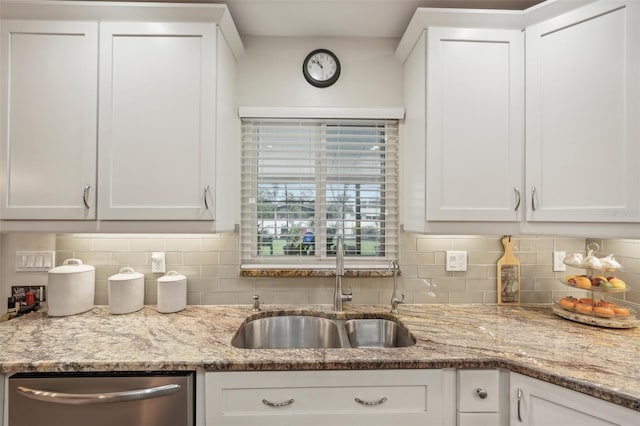 kitchen featuring white cabinets, dishwasher, and sink