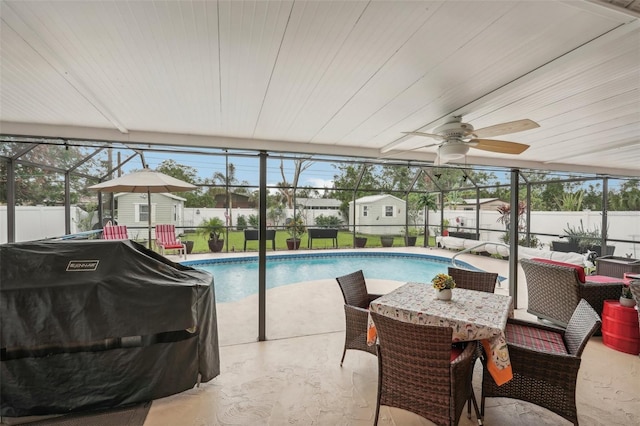 view of swimming pool with area for grilling, a storage shed, and a patio area