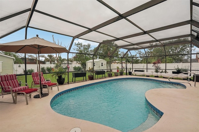 view of pool with a patio area, a lanai, and a storage shed