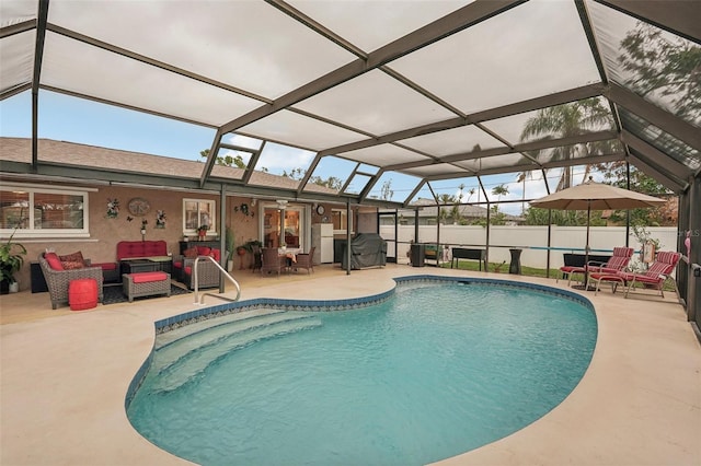 view of pool featuring a lanai, a patio, and an outdoor hangout area