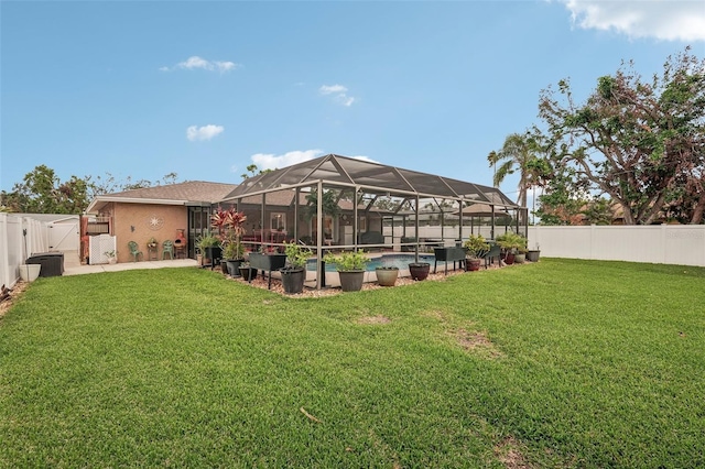 view of yard featuring glass enclosure and a fenced in pool