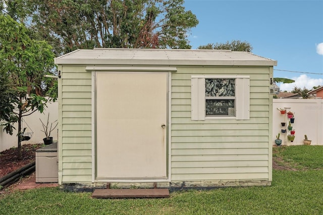 view of outbuilding featuring a yard