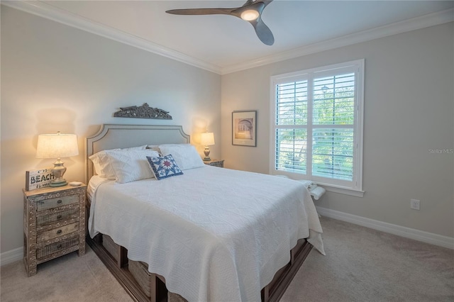 carpeted bedroom featuring ceiling fan and crown molding