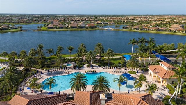 view of pool with a water view and a patio