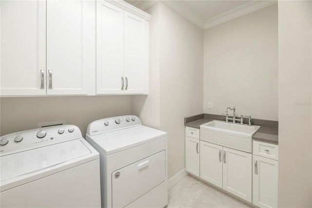 washroom with separate washer and dryer, sink, cabinets, and ornamental molding