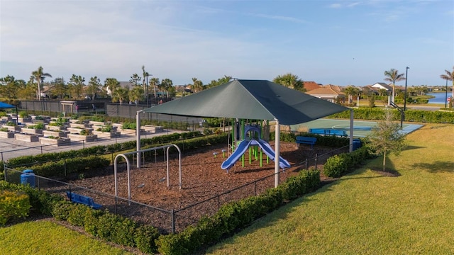 view of play area featuring a yard and a water view