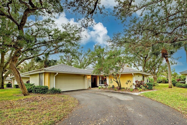 single story home with a front lawn and a garage