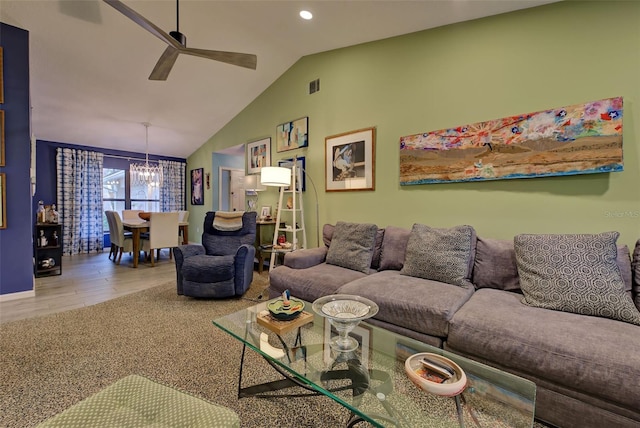 living room with hardwood / wood-style floors, ceiling fan with notable chandelier, and vaulted ceiling