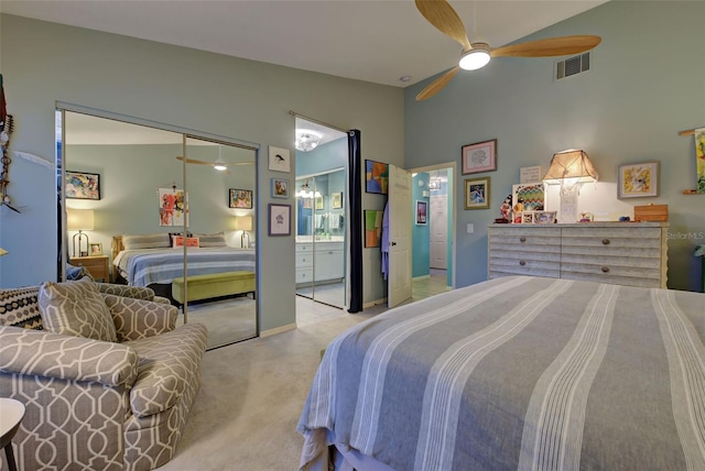 bedroom featuring a closet, light colored carpet, high vaulted ceiling, and ceiling fan