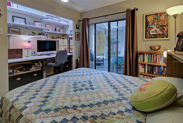 bedroom featuring built in desk and access to outside