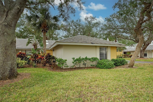 view of property exterior with a yard and stucco siding