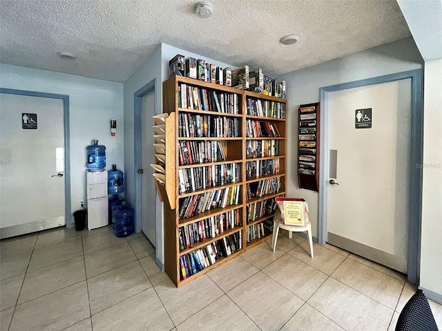 interior space featuring tile patterned flooring and a textured ceiling