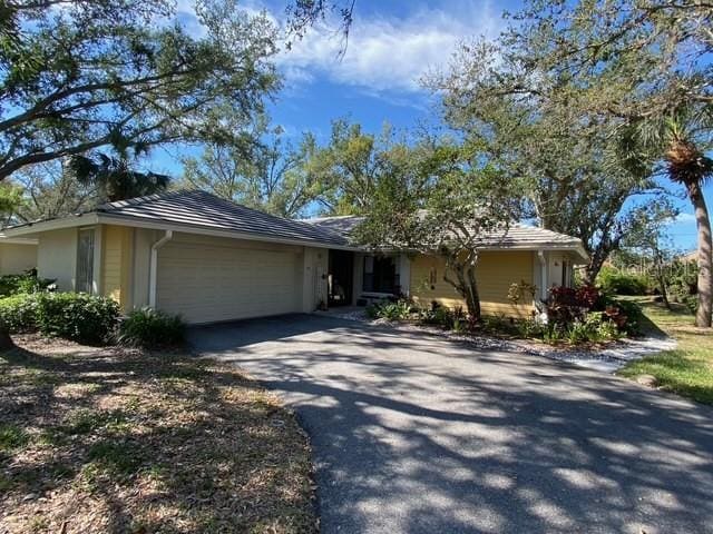 ranch-style home featuring driveway and an attached garage