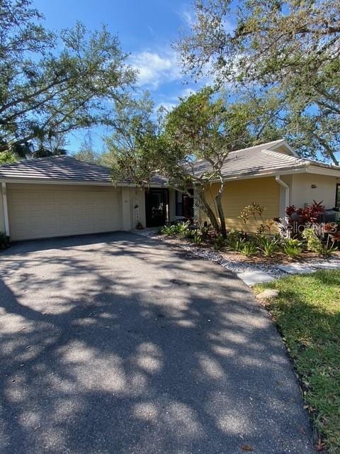 view of front of property with aphalt driveway and a garage