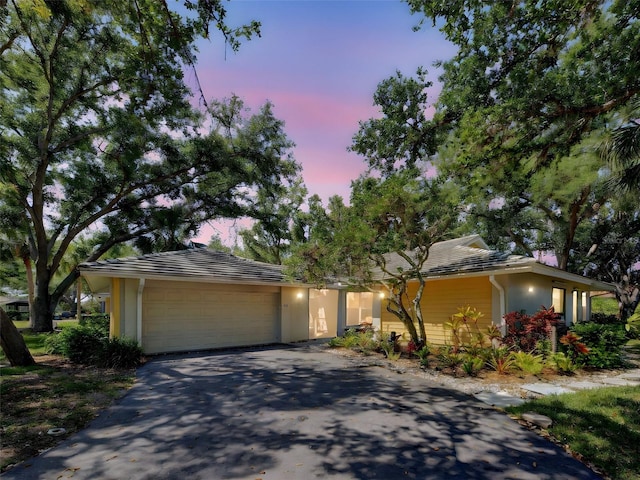 view of front of property featuring driveway, stucco siding, and an attached garage