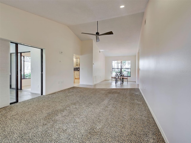 unfurnished room featuring baseboards, high vaulted ceiling, a ceiling fan, and carpet