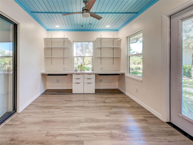 unfurnished office with wood ceiling, ceiling fan, built in study area, and light wood-style floors