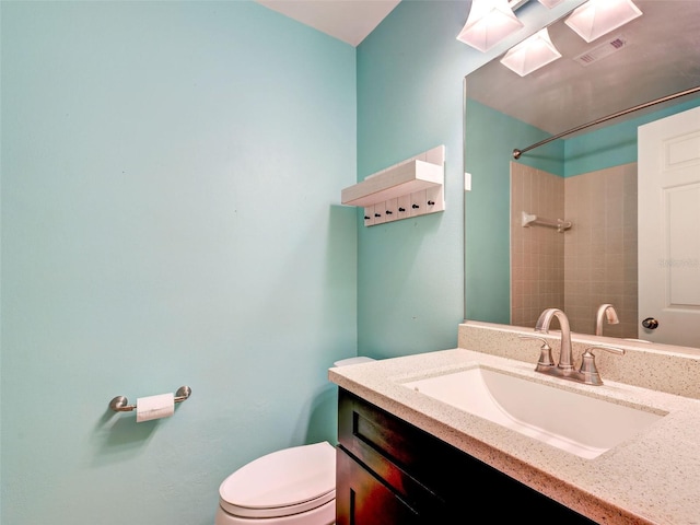 full bathroom featuring toilet, visible vents, walk in shower, and vanity
