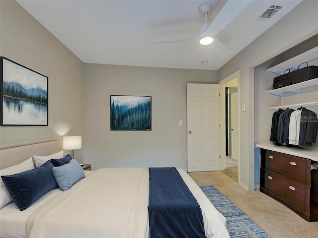 bedroom featuring visible vents, ceiling fan, and light carpet