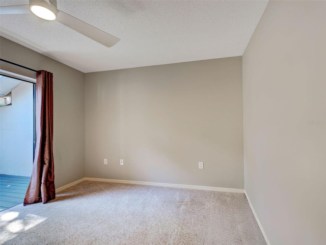 unfurnished room with a textured ceiling, baseboards, a ceiling fan, and carpet floors