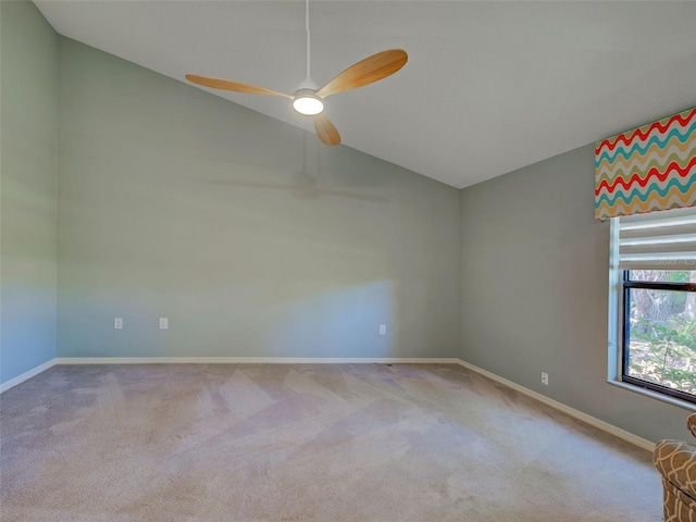 empty room featuring baseboards, a ceiling fan, carpet floors, and lofted ceiling