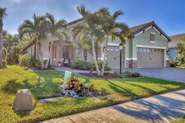 view of front of property with a front yard and a garage