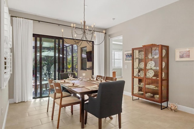 tiled dining area with an inviting chandelier