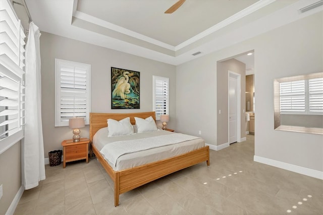 tiled bedroom featuring a raised ceiling and ceiling fan