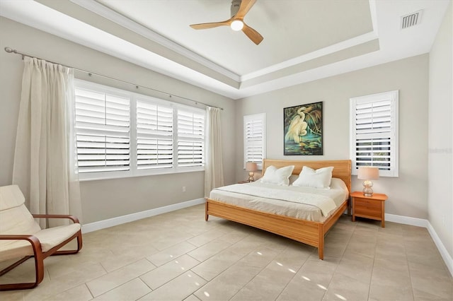 bedroom featuring a tray ceiling, ceiling fan, and light tile patterned floors