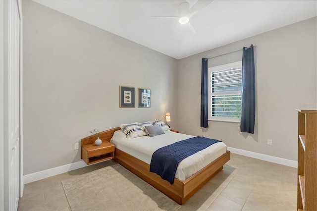 tiled bedroom featuring ceiling fan