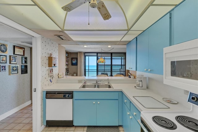 kitchen with blue cabinetry, sink, light tile patterned floors, and white appliances