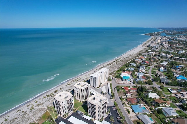 drone / aerial view featuring a water view and a view of the beach