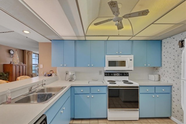 kitchen featuring white appliances, blue cabinets, ceiling fan, sink, and light tile patterned floors