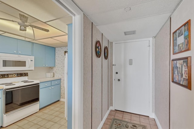 kitchen featuring ceiling fan, light tile patterned flooring, white appliances, and blue cabinets