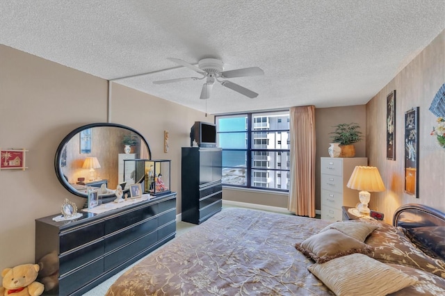 bedroom featuring ceiling fan and a textured ceiling