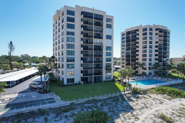 view of building exterior featuring a community pool