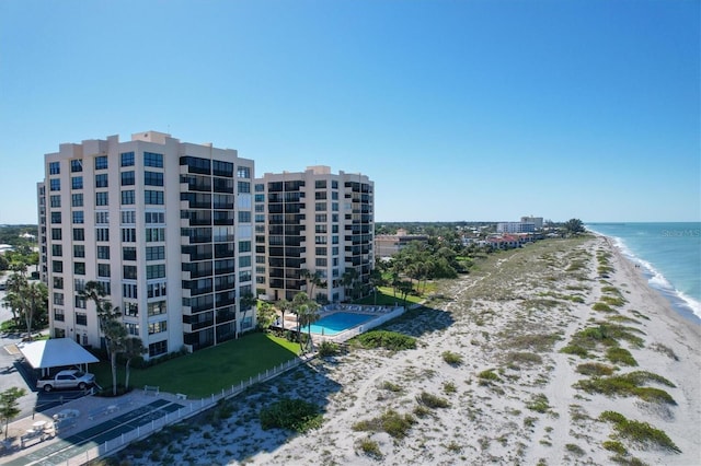 aerial view with a water view and a beach view