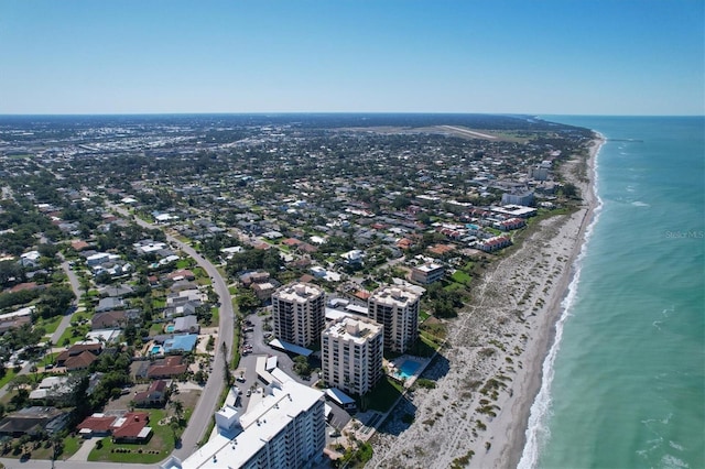 drone / aerial view featuring a water view and a beach view