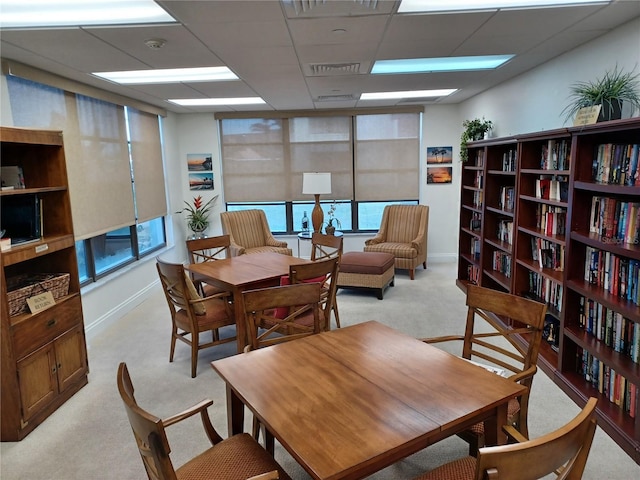 office area featuring a paneled ceiling and light colored carpet