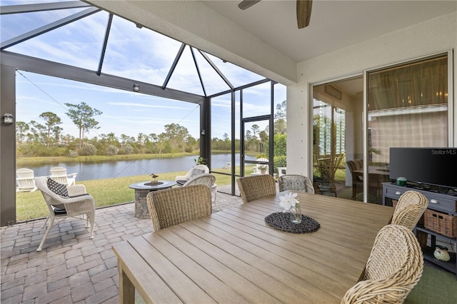 view of patio with ceiling fan and glass enclosure