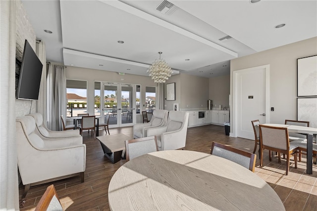 living room with french doors, dark hardwood / wood-style floors, and a chandelier