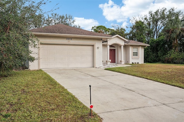 ranch-style house with an attached garage, driveway, a front lawn, and stucco siding