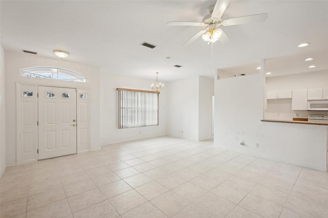 entrance foyer with light tile patterned floors, recessed lighting, visible vents, and ceiling fan with notable chandelier