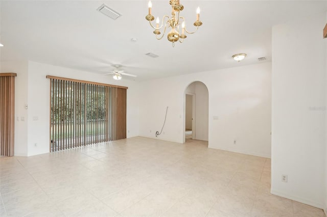 spare room with arched walkways, ceiling fan with notable chandelier, and visible vents