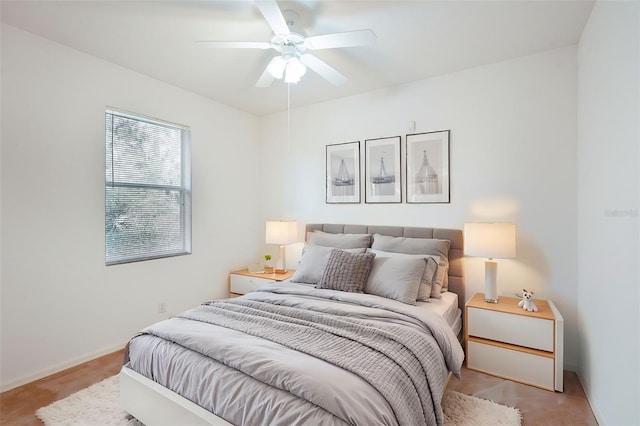 bedroom with baseboards and a ceiling fan