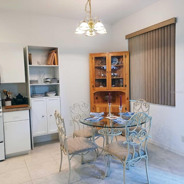 dining room with light tile patterned flooring and a notable chandelier